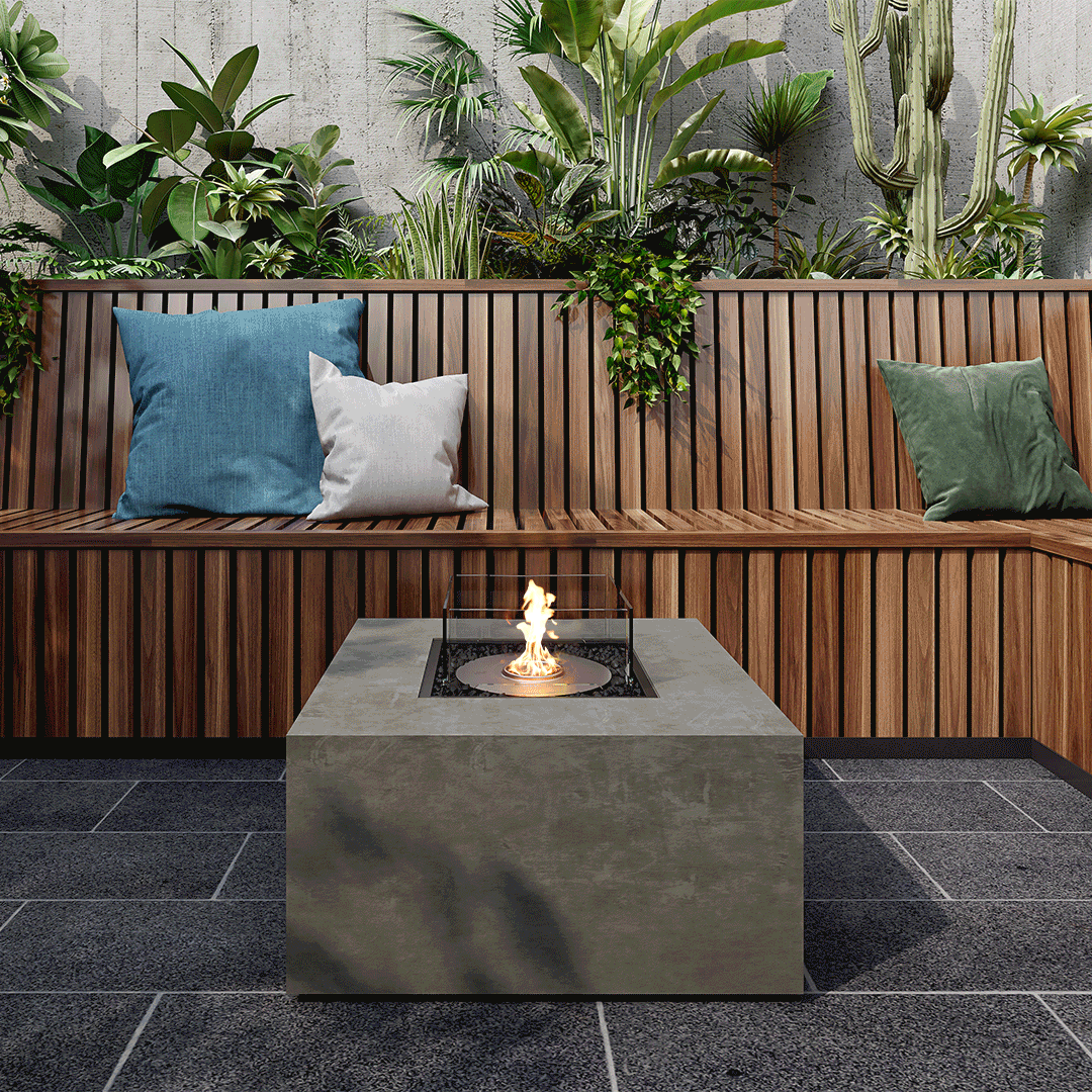 EcoSmart Fire Chaser 38 bioethanol fire pit table with a grey concrete finish and glass screen on a stone patio.