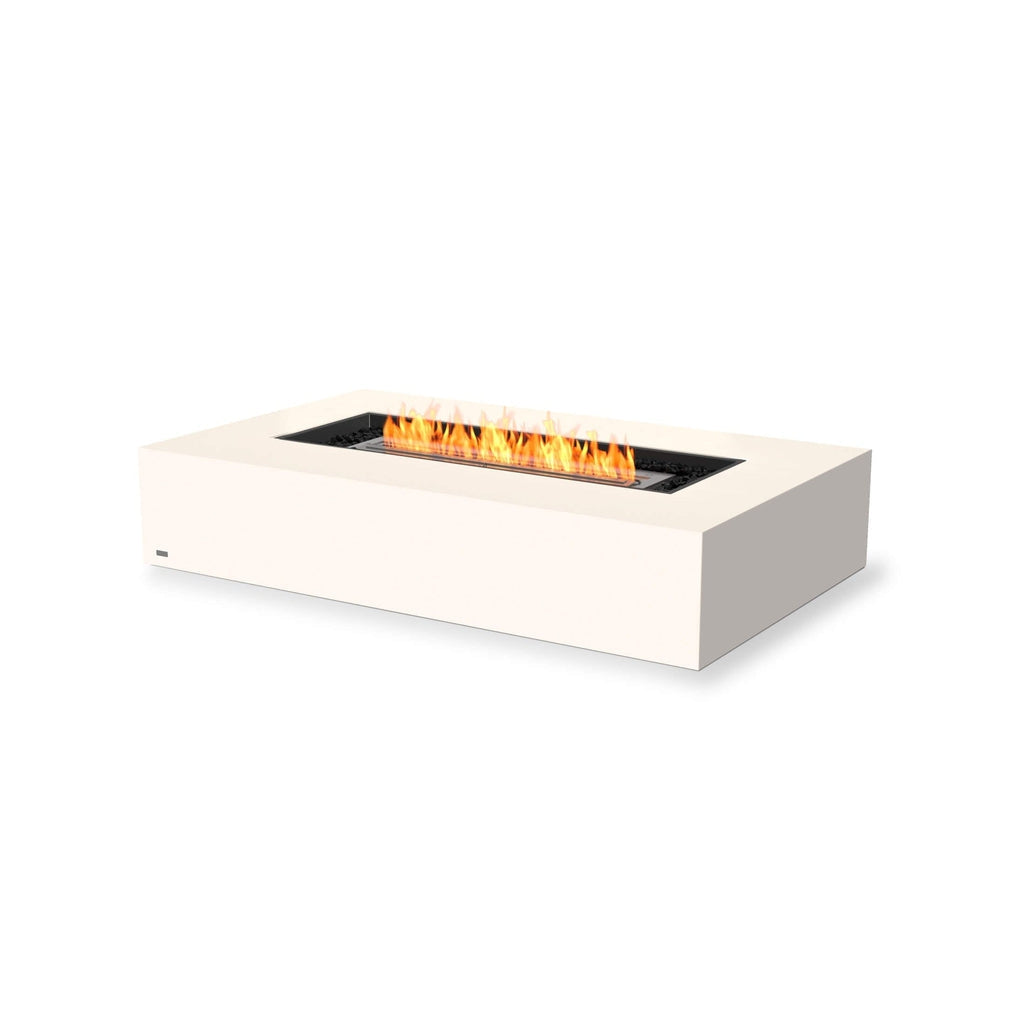 EcoSmart Fire Wharf 65 ethanol fire pit table in bone white with a rectangular flame and black decorative stones.