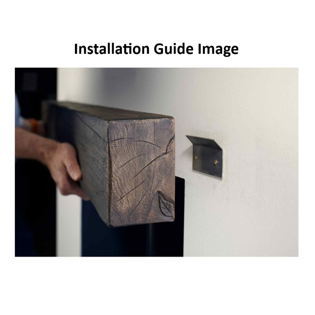 Person installing a dark wood-finish OER Classic 48 inch fireplace beam onto a wall-mounted metal bracket.