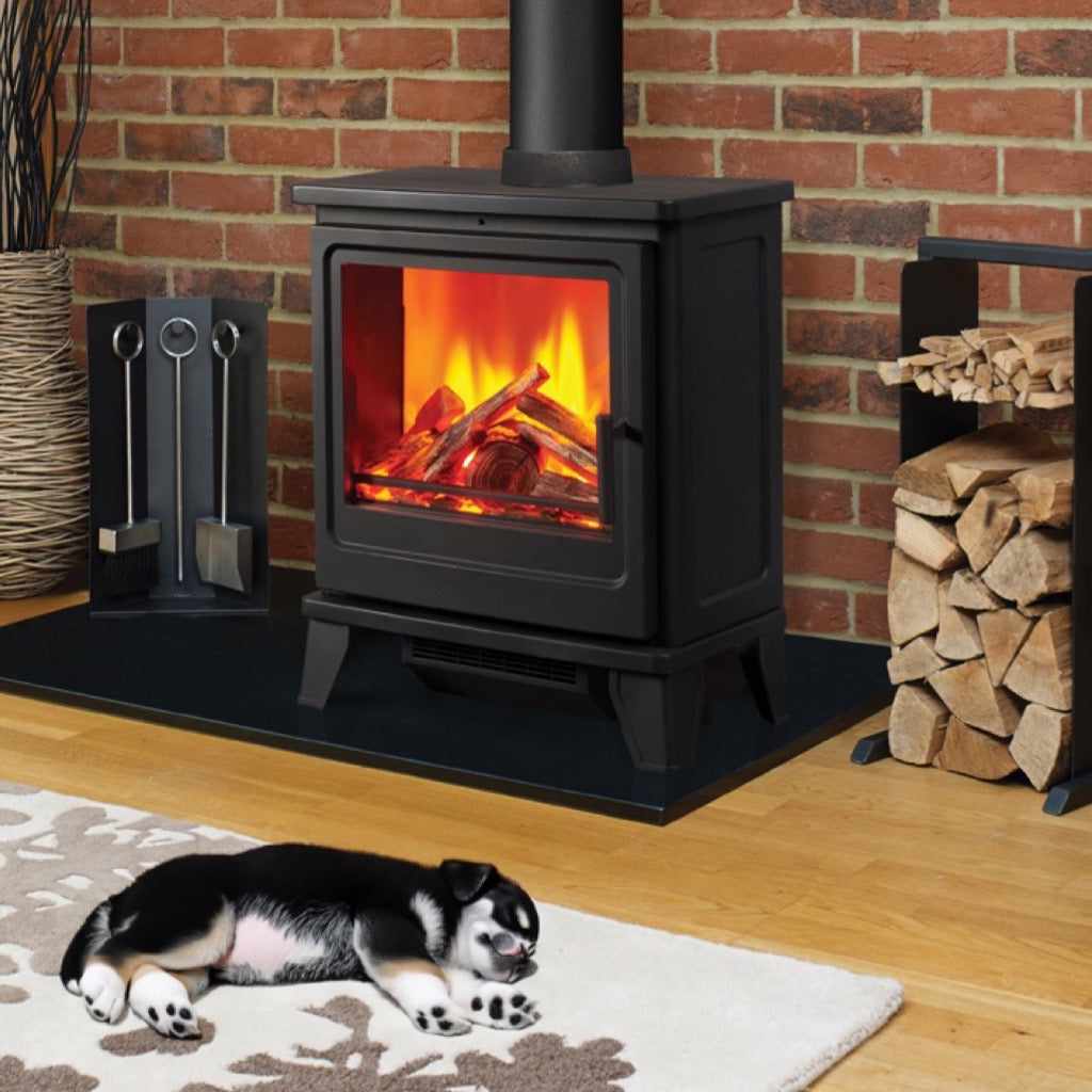 Solution Fires Blackthorn electric stove with a realistic flame effect, set on a hearth before a brick wall.