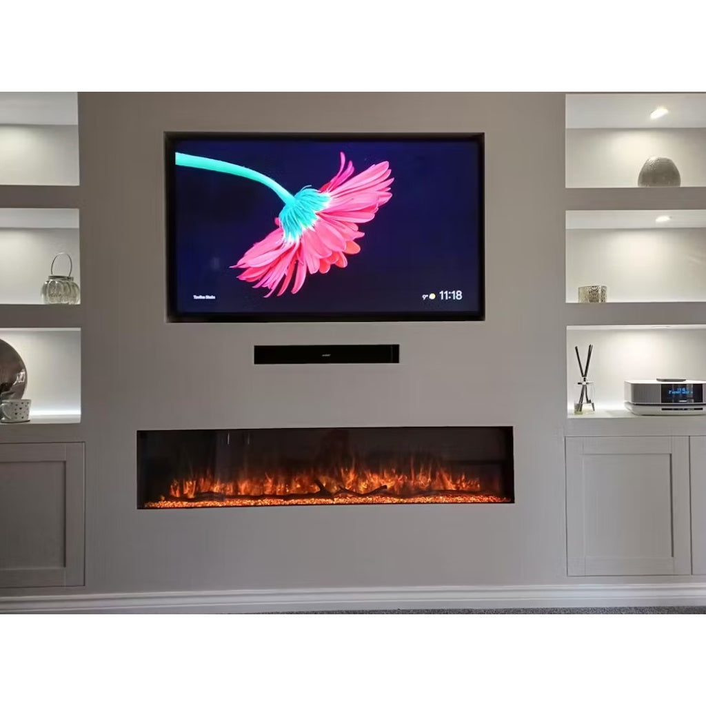 Recessed borderless electric fire with orange LED flames, set in a grey media wall with shelving and a mounted TV.