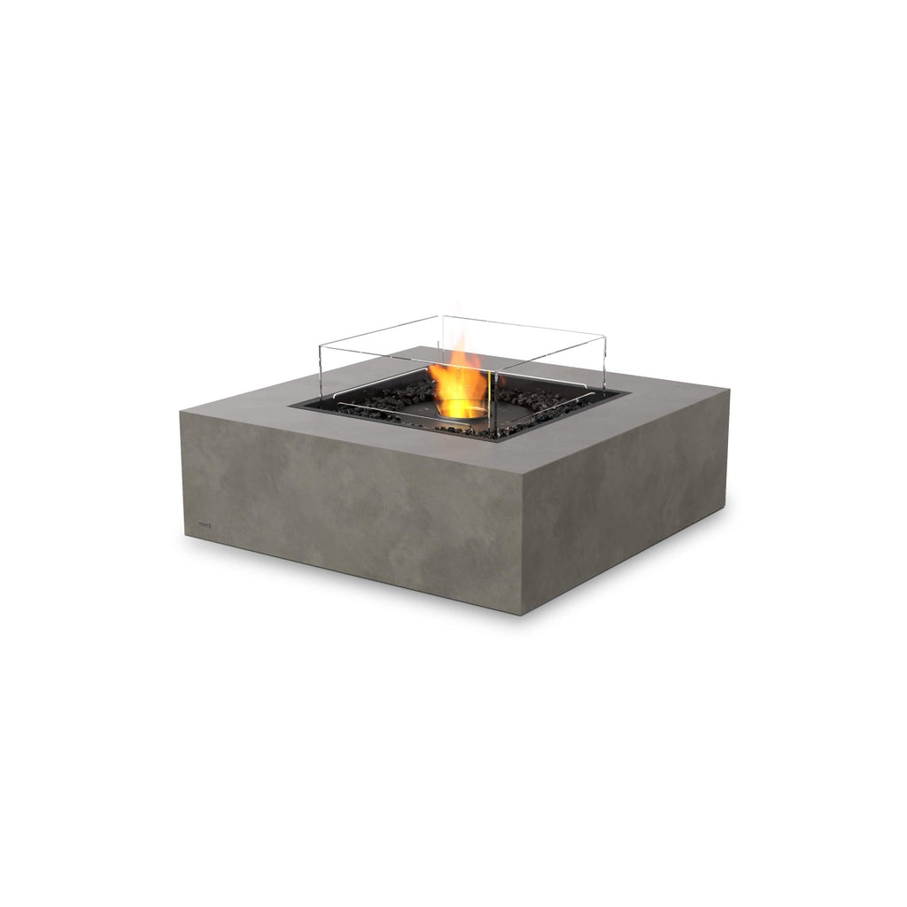 EcoSmart Fire Base 40 bioethanol fire pit table in grey concrete with a central flame and glass fire screen.