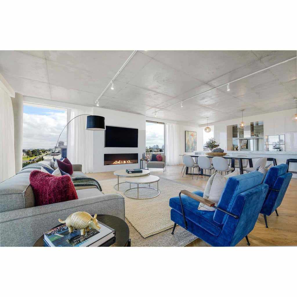 EcoSmart Fire Flex 68 bioethanol fireplace insert set into a white wall in a modern, open-plan living room.