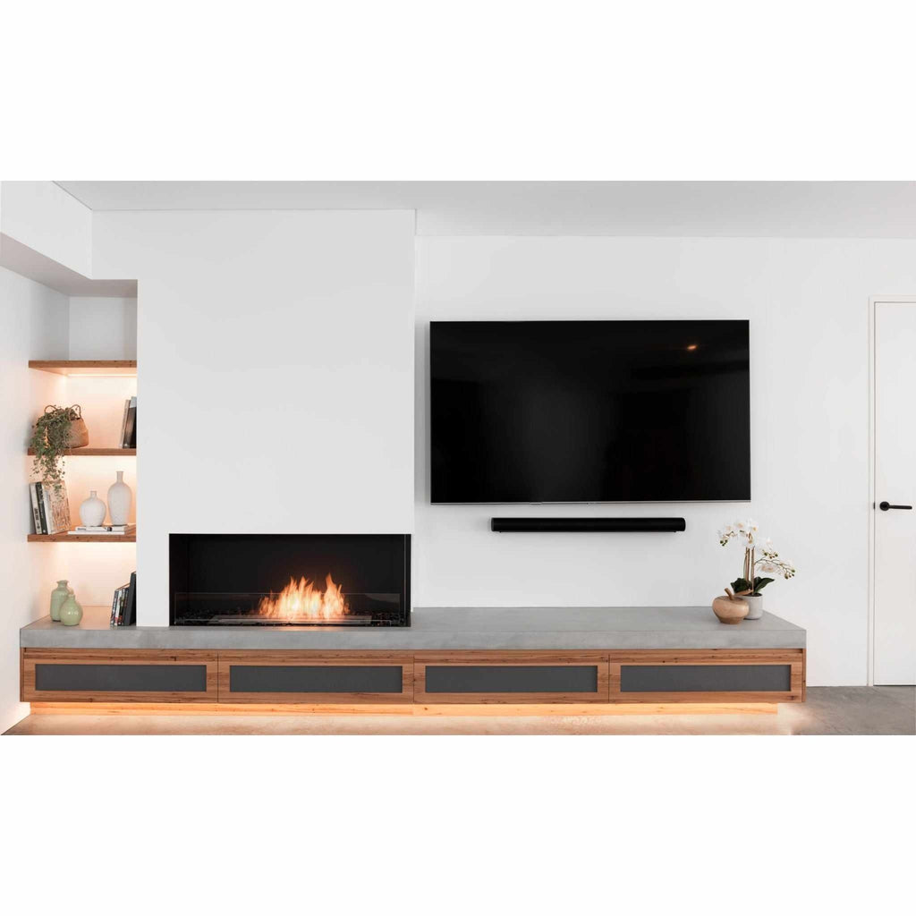 EcoSmart Fire Flex 68 bioethanol fireplace set in a concrete hearth with wood cabinetry and a wall-mounted television.