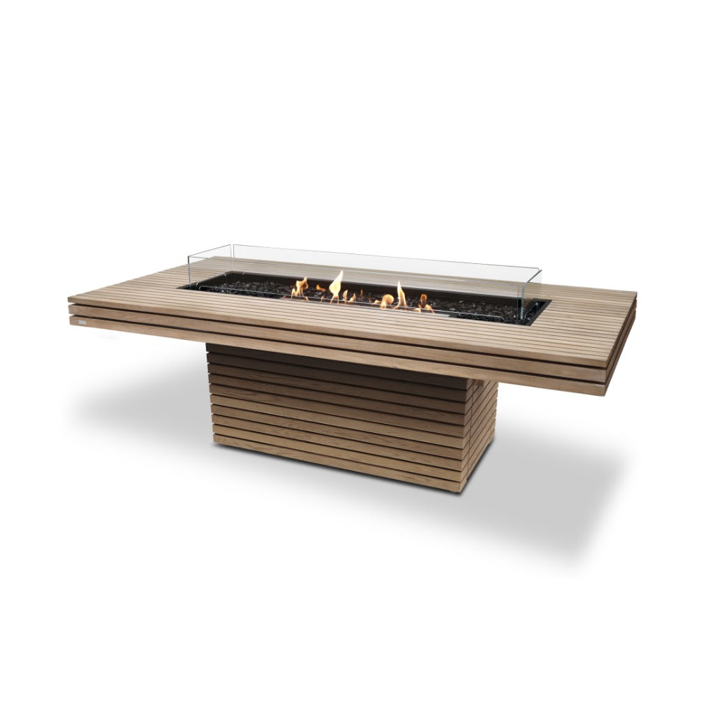 EcoSmart Fire Gin 90 dining table with a slatted teak finish, central bioethanol burner, and glass fire screen.