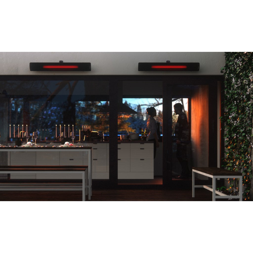 Two black Heatscope Pure+ 3000W heaters mounted above a patio door, glowing red in a modern outdoor dining setting.