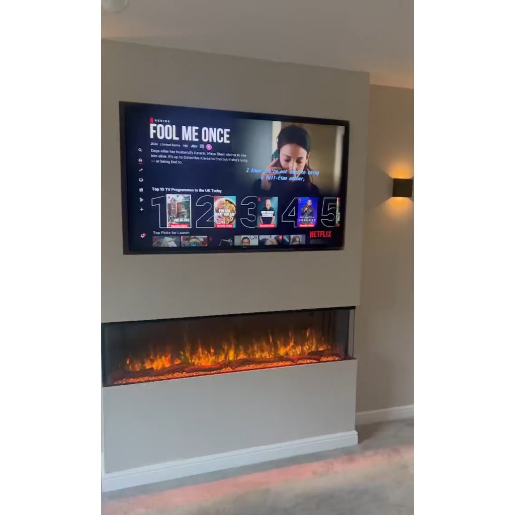 Luvelle 60” 3D panoramic electric fire set in a beige media wall with a mounted television above.