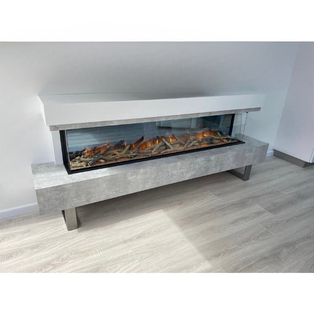 OER Olympia 1500 electric fireplace with a grey concrete-effect base, white mantel, and three-sided glass fire display.