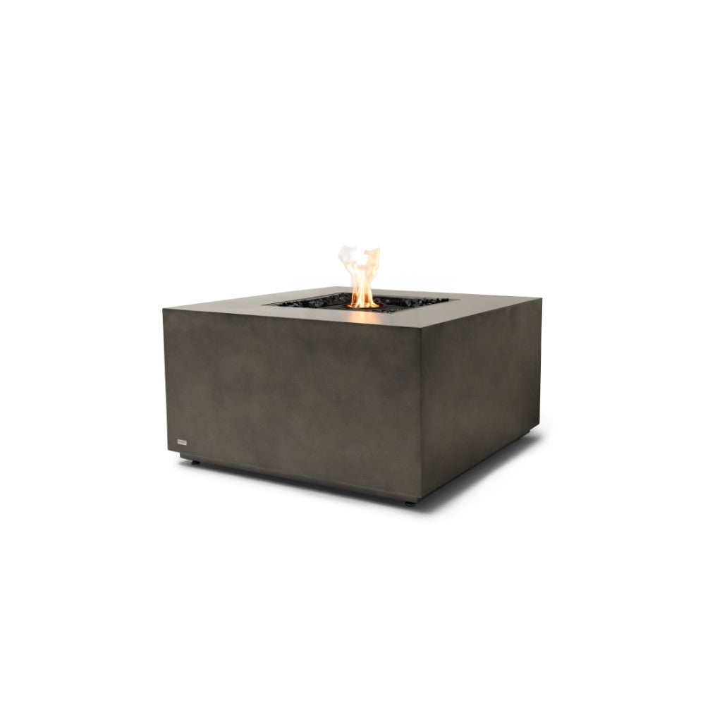 EcoSmart Fire Chaser 38 square grey concrete fire pit table with a central flame and black decorative stones.