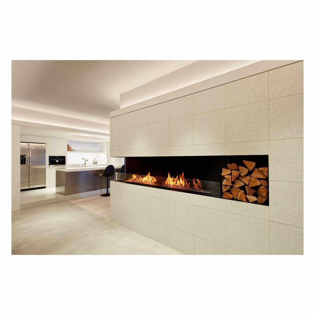 EcoSmart Fire Flex 104 fireplace insert with a linear flame and log storage in a tiled wall in a modern kitchen.