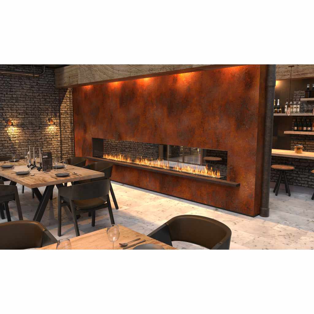 EcoSmart Fire Flex 32 bioethanol fireplace insert set into a rustic, weathered metal wall in a restaurant setting.