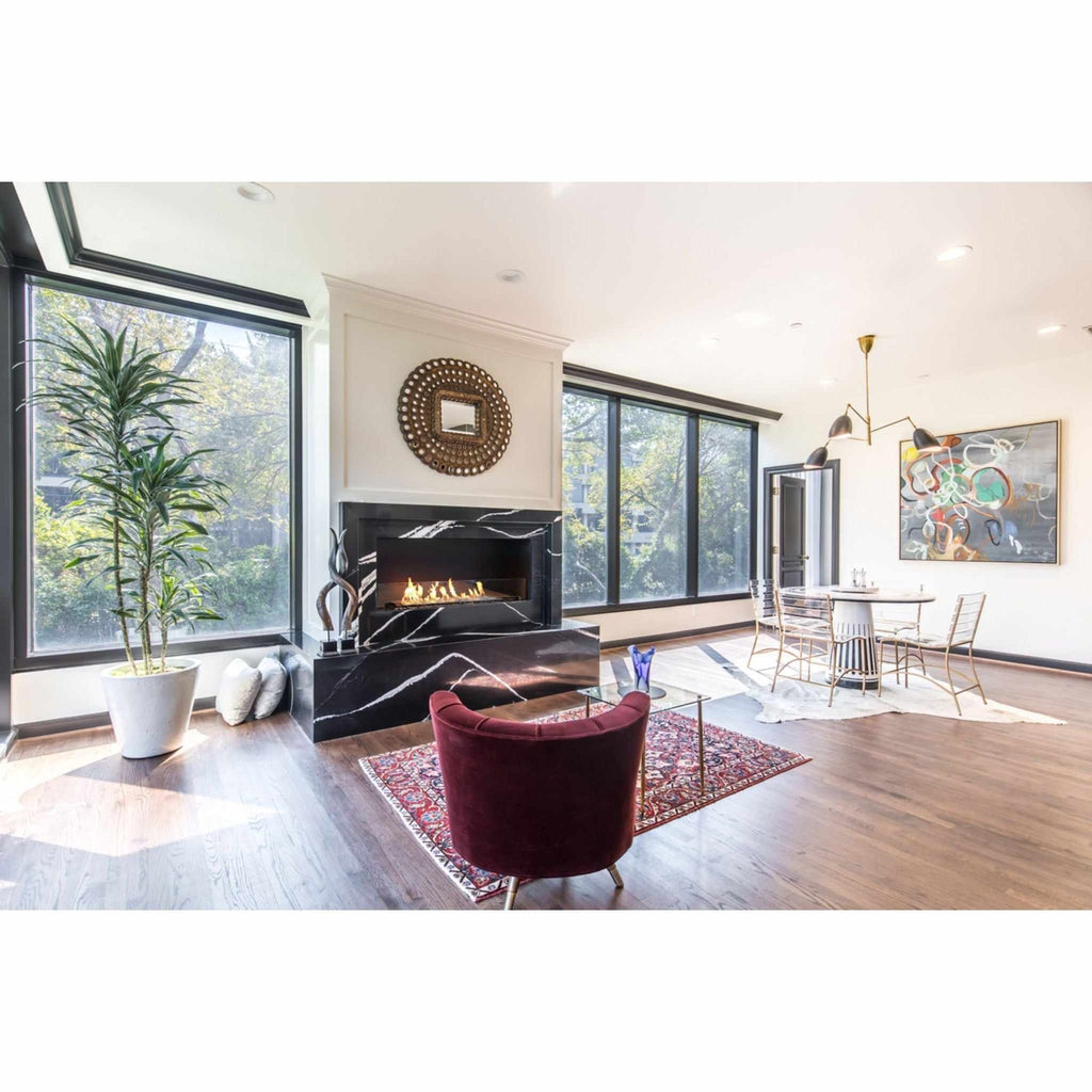 EcoSmart Fire Flex 42 bioethanol fireplace insert set in a black marble surround within a modern living room.