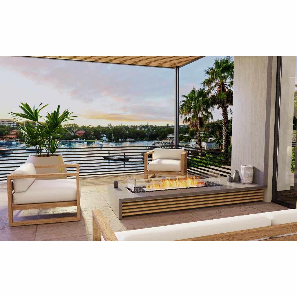 EcoSmart Fire Flex 42 bioethanol fireplace with a linear flame on a grey stone base set on a modern outdoor terrace.