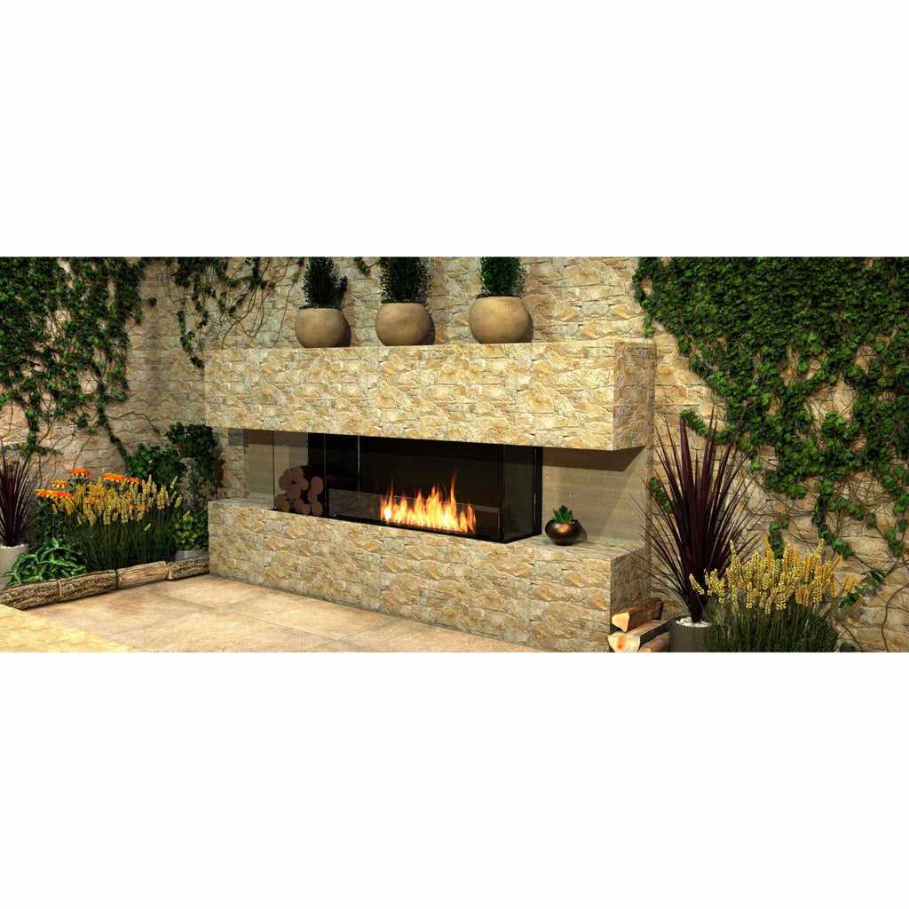 EcoSmart Fire Flex 50 bioethanol fireplace set in a rustic stone wall with a visible flame and glass surround.