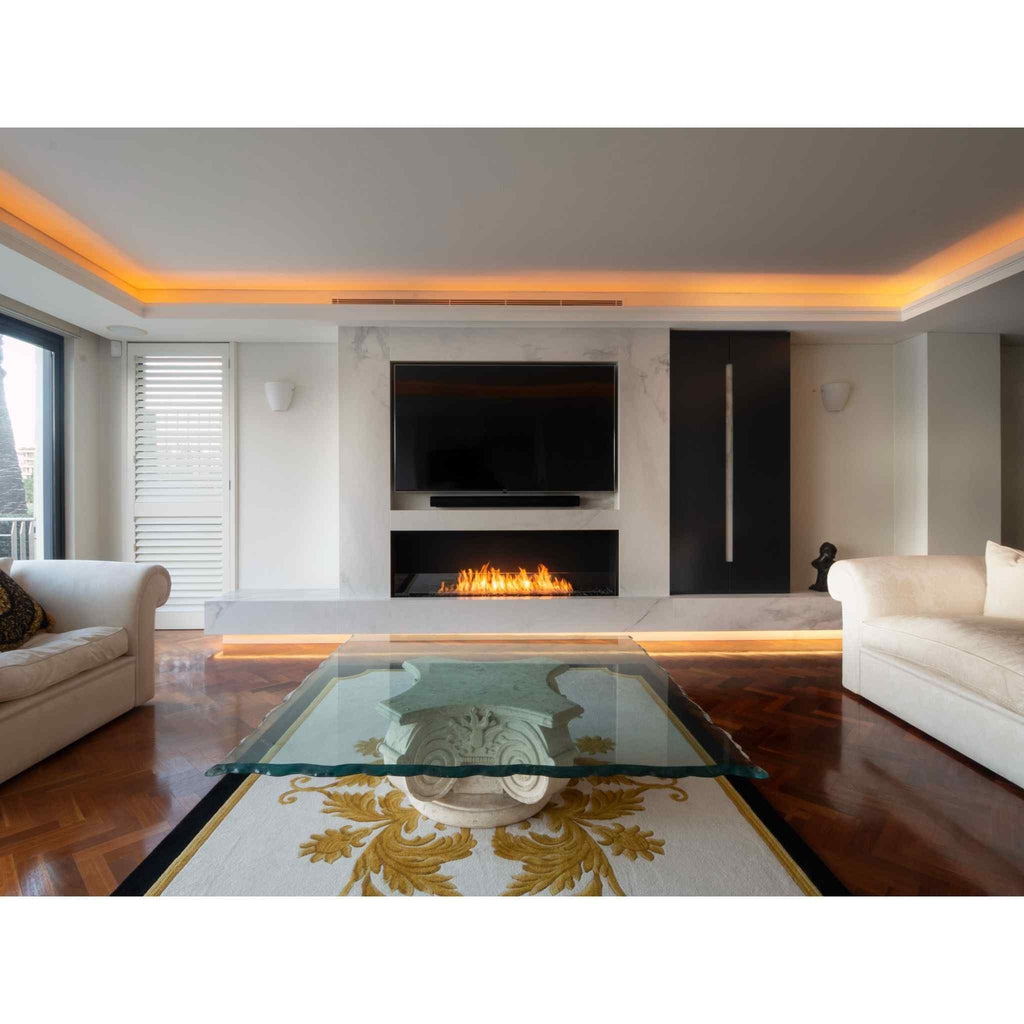 EcoSmart Fire Flex 50 bioethanol fireplace insert set into a white marble wall below a wall-mounted television.
