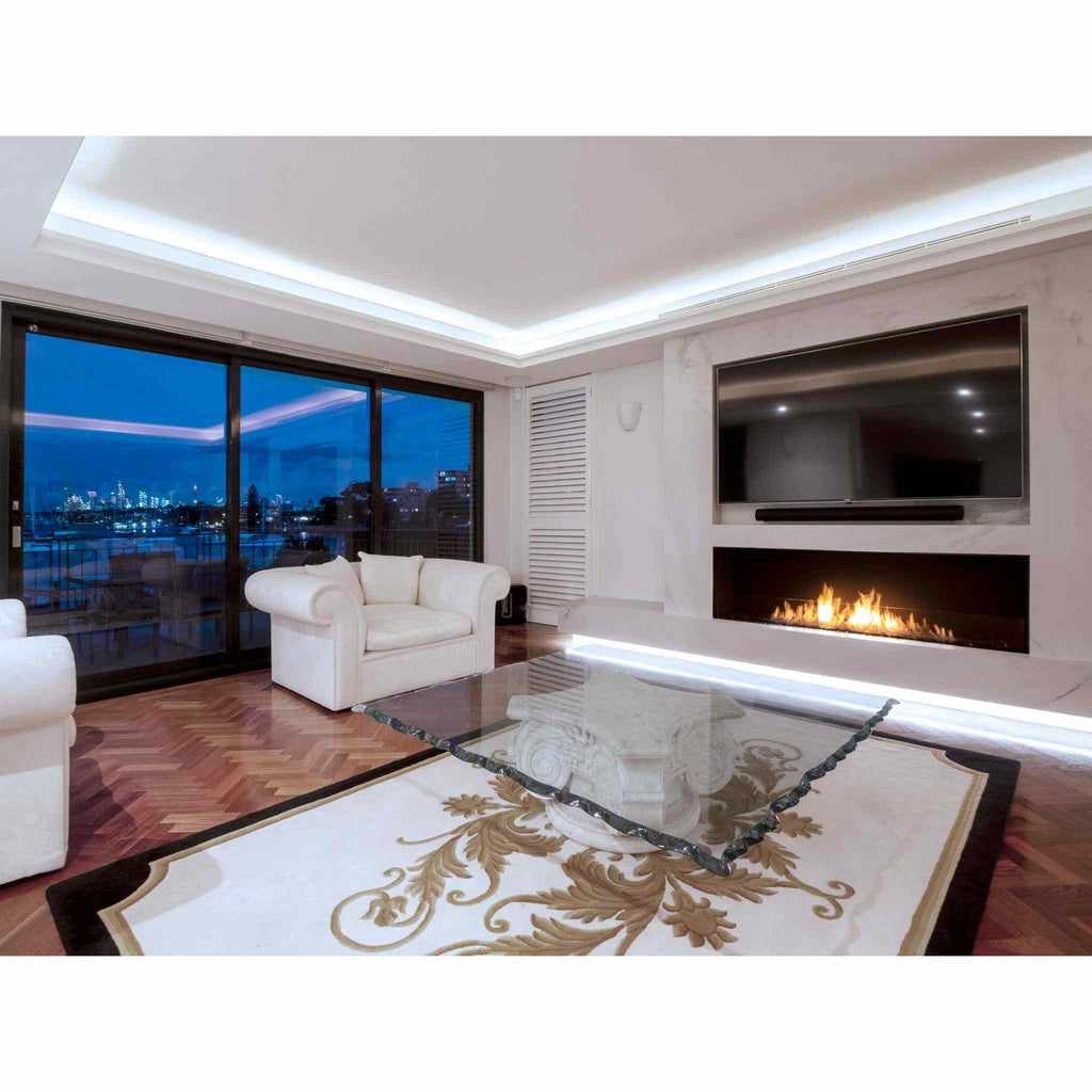 EcoSmart Fire Flex 68 bioethanol fireplace insert with a long, linear flame set into a white marble wall.