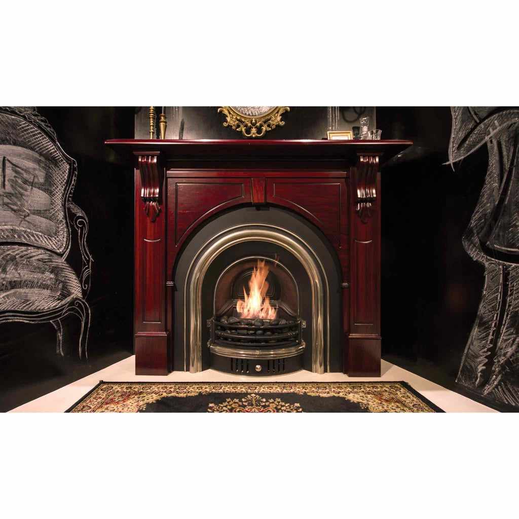 EcoSmart Fire VB2 ethanol burner with a flickering flame inside a traditional dark wood fireplace surround.