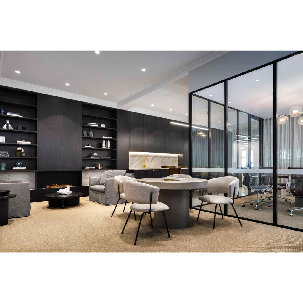 EcoSmart Fire XL1200 ethanol burner integrated into a dark wood wall in a modern office lounge with beige carpet.