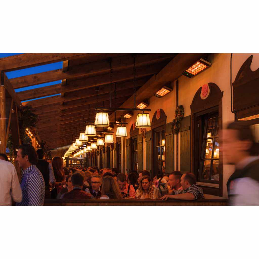 Heatscope Heaters Spot 1600W electric radiant heaters mounted on a wooden ceiling above a busy outdoor restaurant.