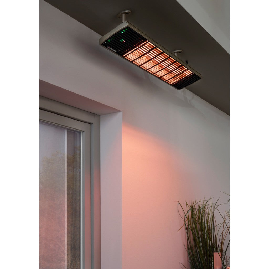 Heatscope Heaters Spot 1600W electric radiant heater mounted on a ceiling, glowing orange with a black grille.