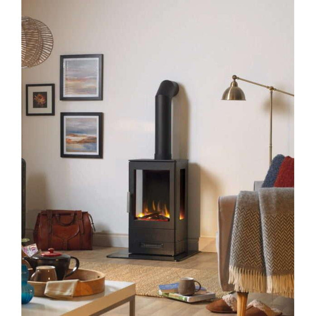 ACR E-Trinity3 electric stove with a black finish and glass side panels, standing on a hearth in a living room.