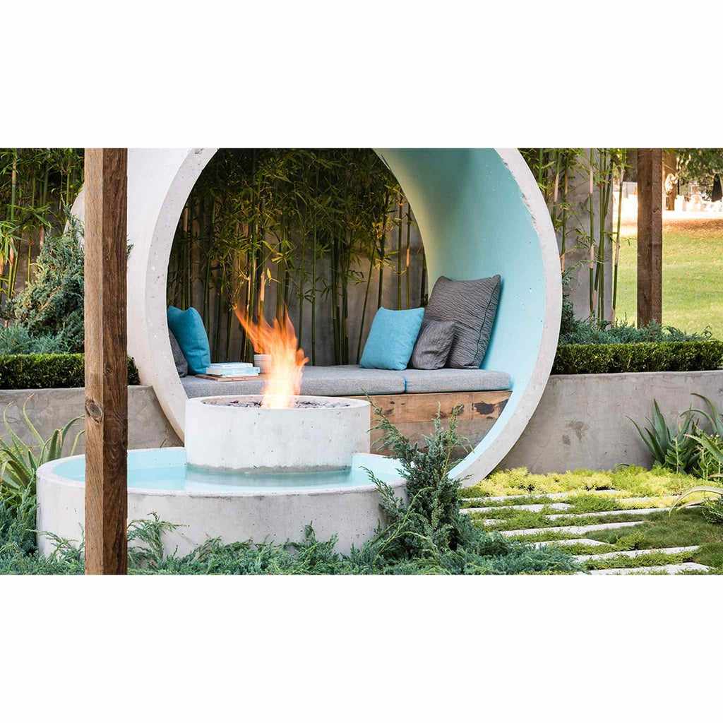 EcoSmart Fire AB8 Ethanol Burner with top tray in a circular concrete fire feature set in a modern garden.
