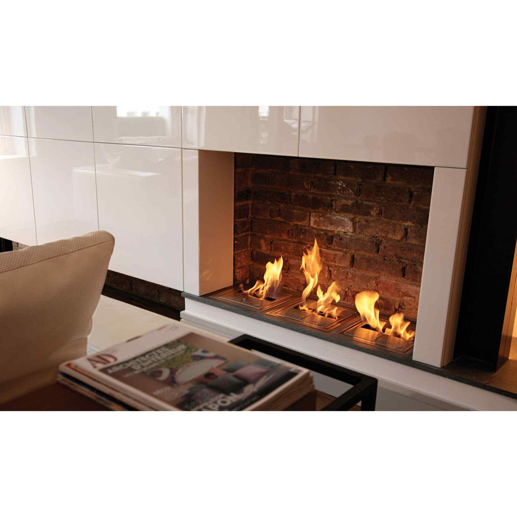 EcoSmart Fire BK5 ethanol burner with three active flames set into a rustic brick fireplace with white cabinetry.