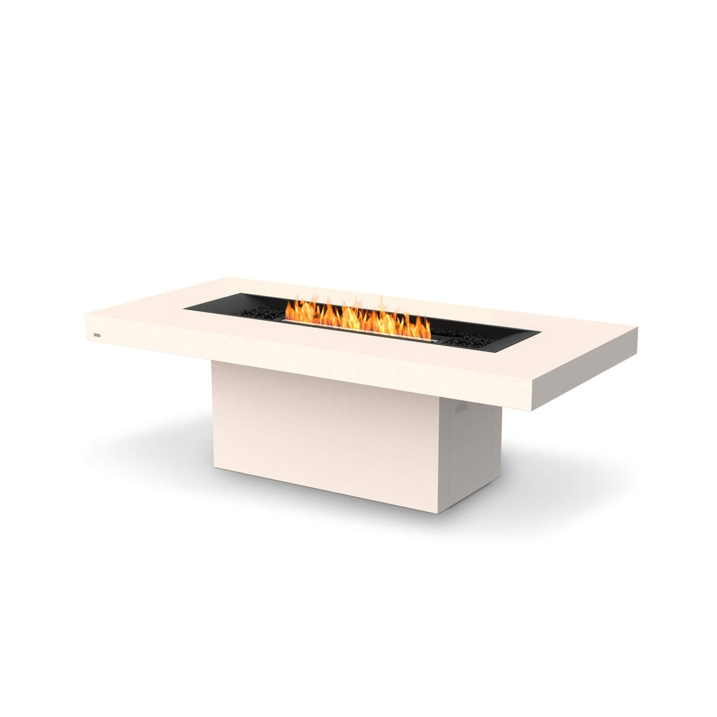 EcoSmart Fire Gin 90 dining fire pit table in bone finish with a central black burner and flickering orange flames.