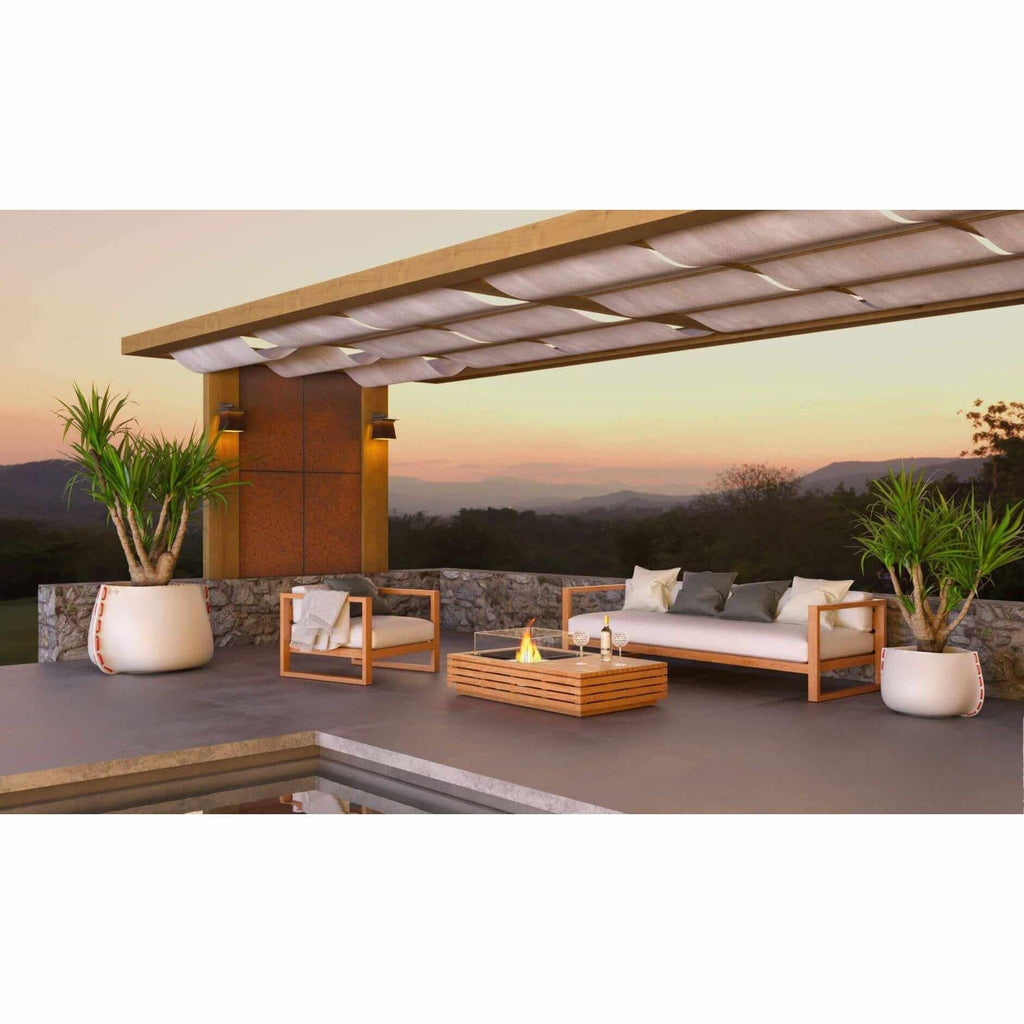EcoSmart Fire Manhattan 50 bioethanol fire pit table with a slatted timber finish on a modern outdoor terrace.