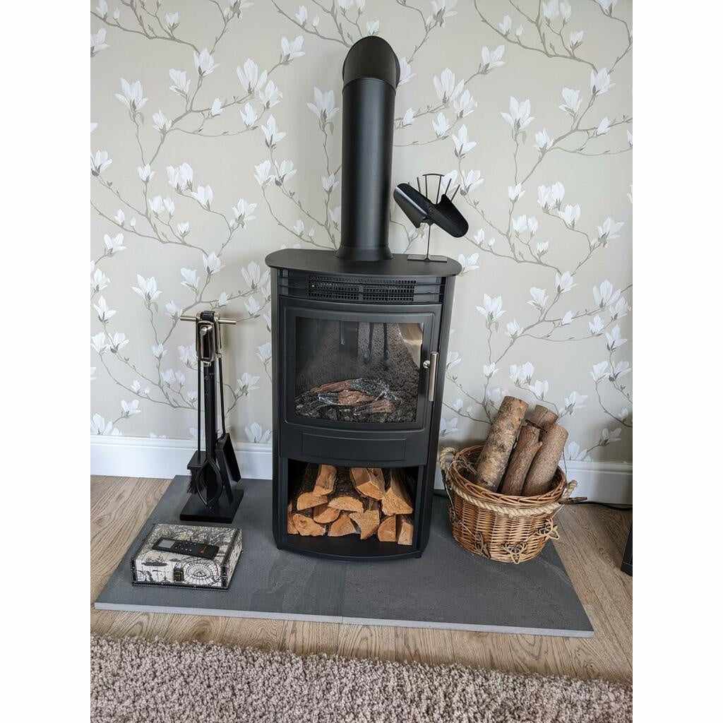 Flametek Alto T electric stove in black, featuring a flue pipe, log storage base, and companion set on a grey hearth.