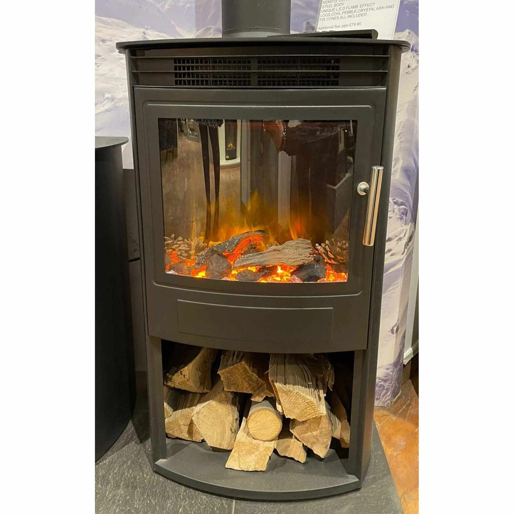 Flametek Alto T electric stove in black steel with a glass door, glowing log-effect flame, and log storage base.