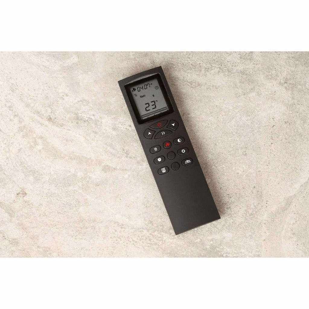 Black Flametek Brooklyn Electric Fireplace remote control with an LCD screen and button interface on a stone surface.