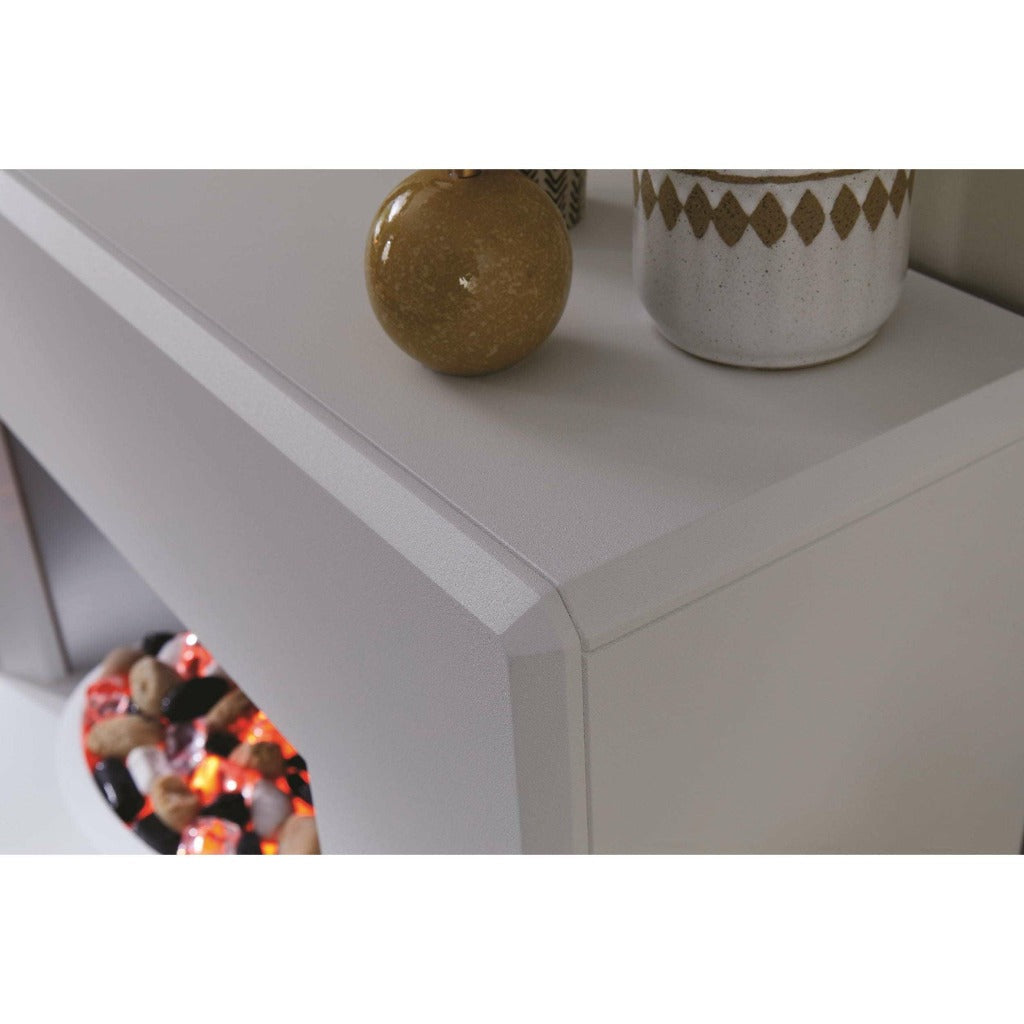 Close-up of the Suncrest Stockeld Electric Fireplace Suite with a smooth, matte cream finish and glowing pebble fuel bed.